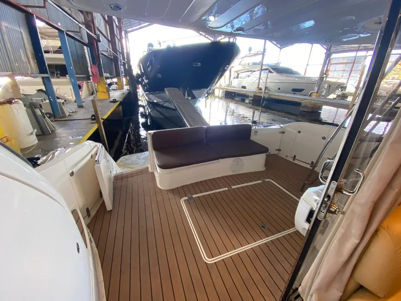 Slide: The Image of 2001 Fairline Squadron 55 yacht with spacious deck in marina setting. - 14