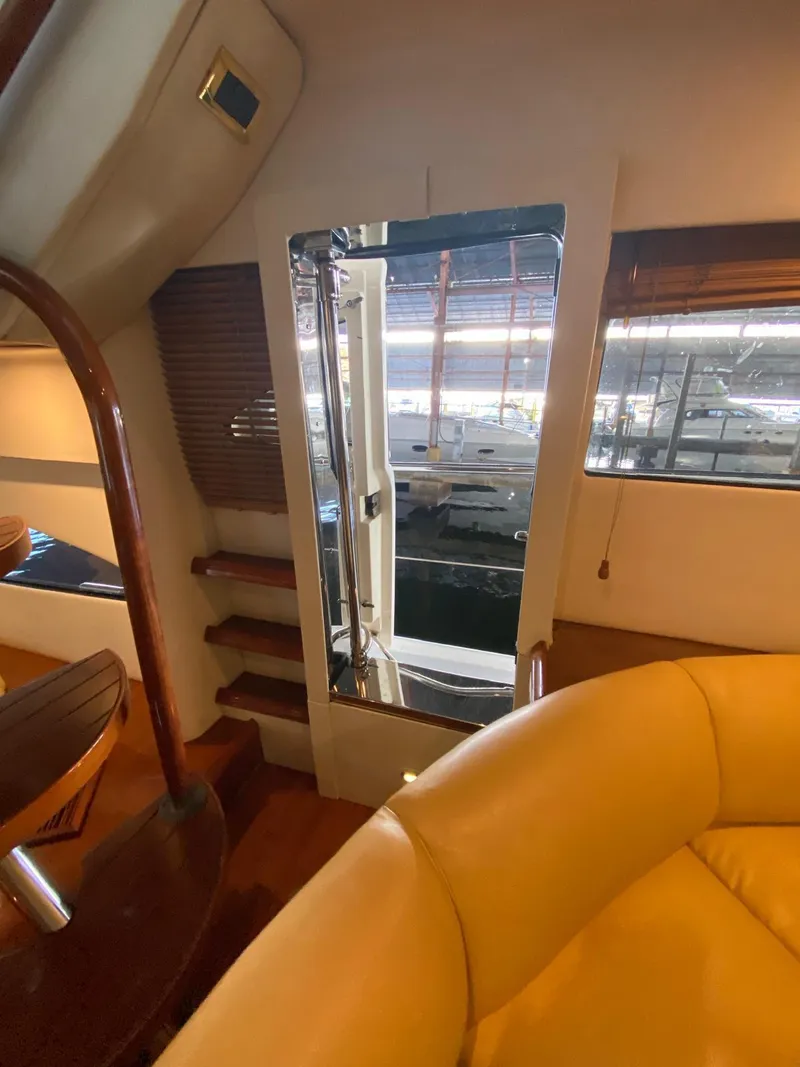 Slide: The Image of Interior of 2001 Fairline Squadron 55 yacht, featuring stairs and luxurious seating. - 23
