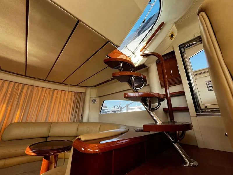 Slide: The Image of Luxurious interior of 2001 Fairline Squadron 55 yacht with elegant staircase and seating area. - 24