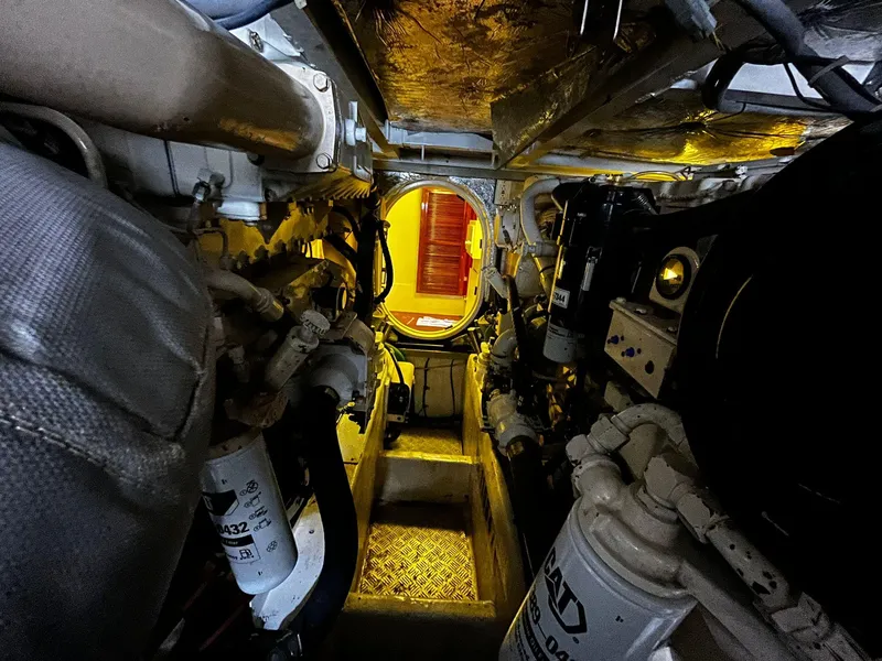 Slide: The Image of Engine room of 2001 Fairline Squadron 55 yacht, showcasing mechanical components and access hatch. - 38