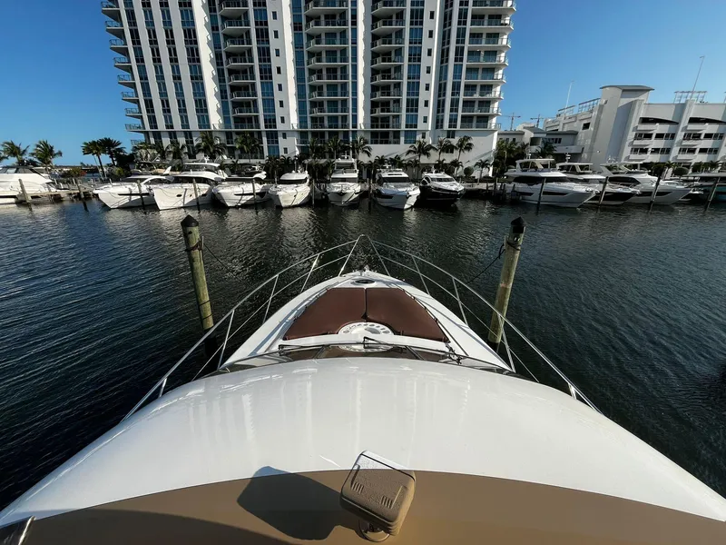 Slide: The Image of Bow view of 2001 Fairline Squadron 55 yacht docked near luxury waterfront buildings. - 6
