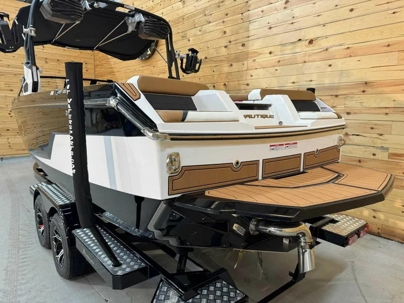 Slide: The Image of 2024 Nautique GS24 boat on trailer in wooden garage setting. - 3