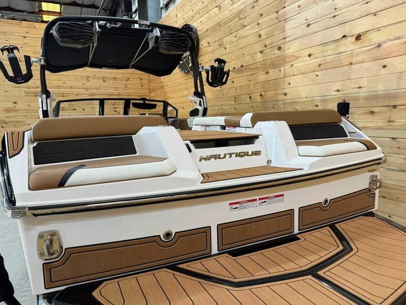 Slide: The Image of 2024 Nautique GS24 boat with sleek design, brown and white seating, and wooden deck. - 4