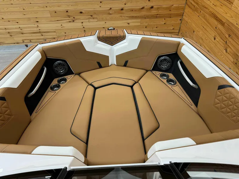 Slide: The Image of 2024 Nautique GS24 boat interior with tan upholstery and modern design. - 7