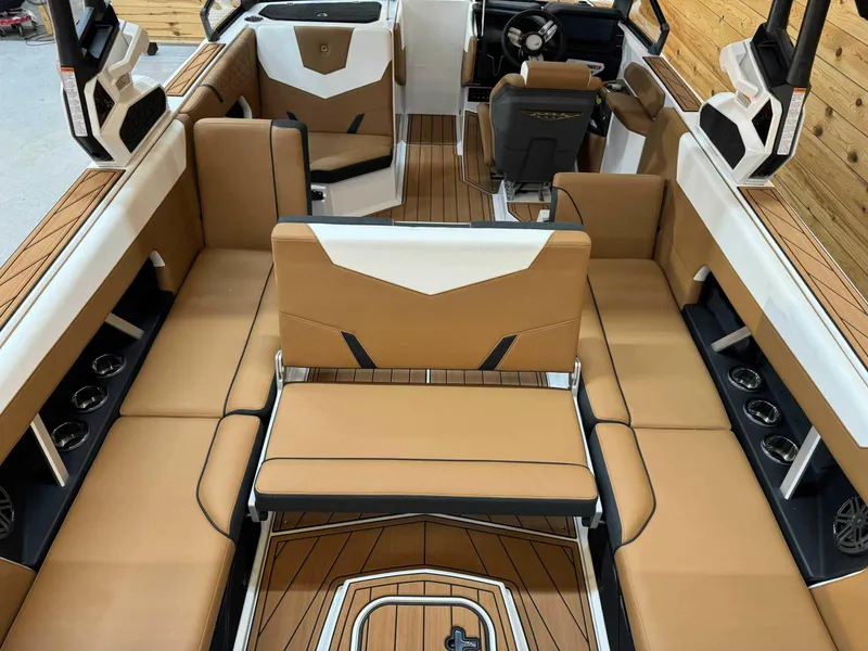 Slide: The Image of 2024 Nautique GS24 boat interior with tan seating and modern design. - 9