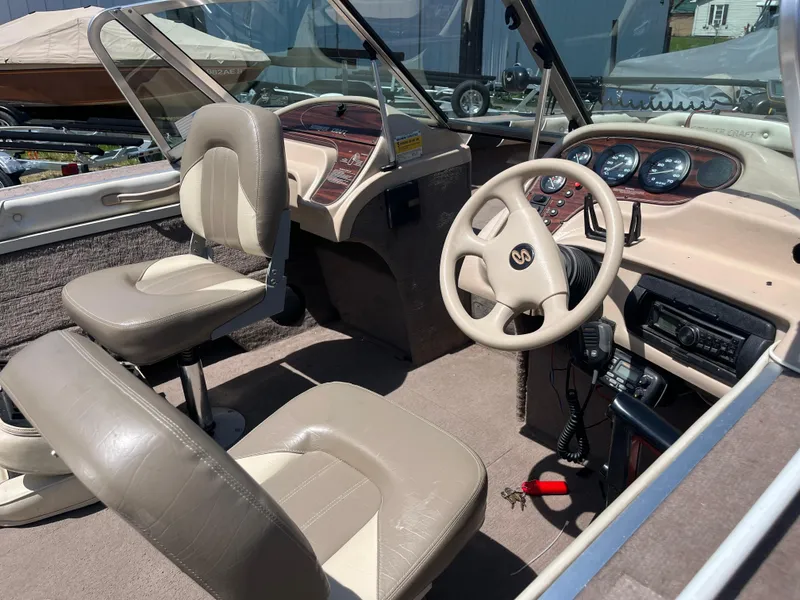 Slide: The Image of 1997 Smoker Craft 170 PHANTOM boat interior with beige seats and dashboard controls. - 3