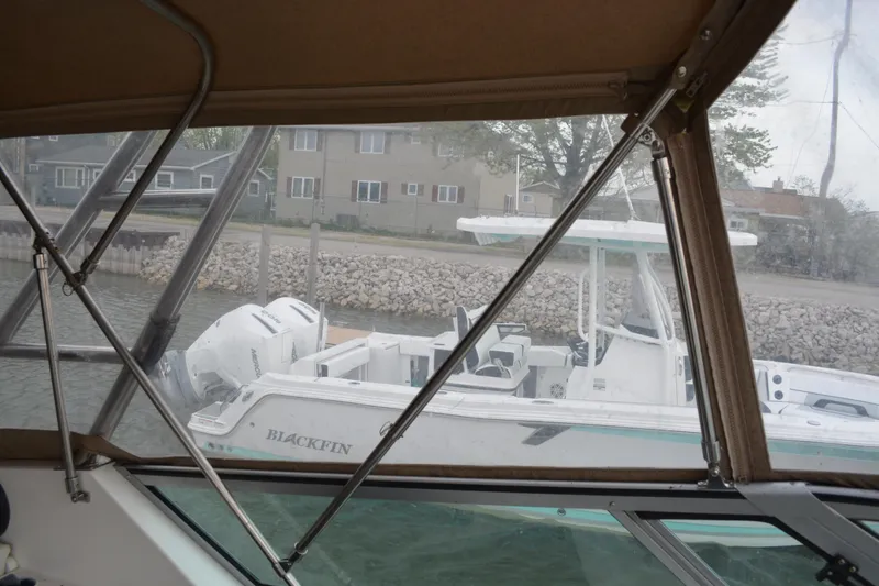 Slide: The Image of 1997 Cruisers Yachts 3120 Aria interior view with docked boat outside. - 15