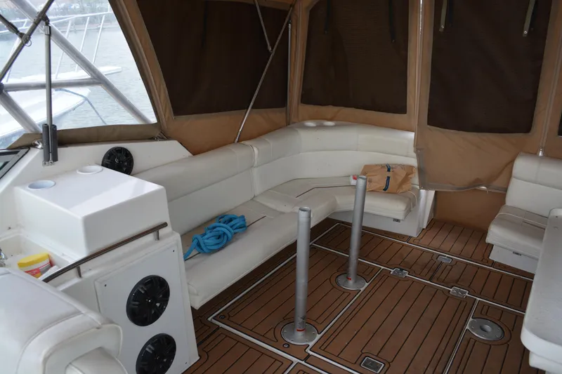 Slide: The Image of 1997 Cruisers Yachts 3120 Aria interior with white seating and wooden flooring. - 16