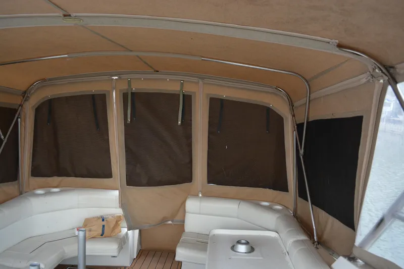 Slide: The Image of 1997 Cruisers Yachts 3120 Aria interior with beige canopy and white seating. - 18