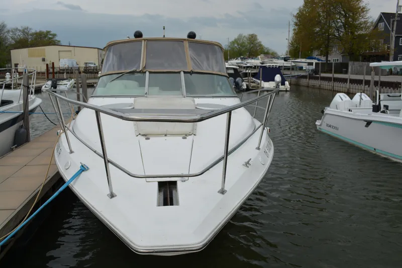Slide: The Image of 1997 Cruisers Yachts 3120 Aria docked in a marina, front view. - 2
