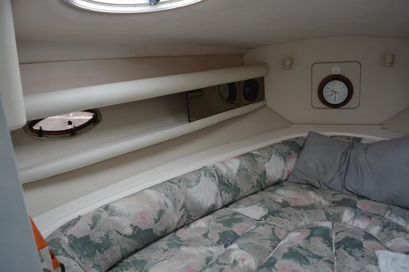 Slide: The Image of Interior cabin of 1997 Cruisers Yachts 3120 Aria with floral upholstery and porthole. - 23