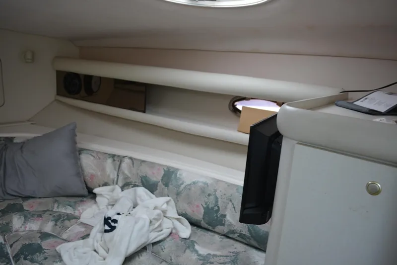 Slide: The Image of 1997 Cruisers Yachts 3120 Aria cabin interior with floral seating and storage shelves. - 24