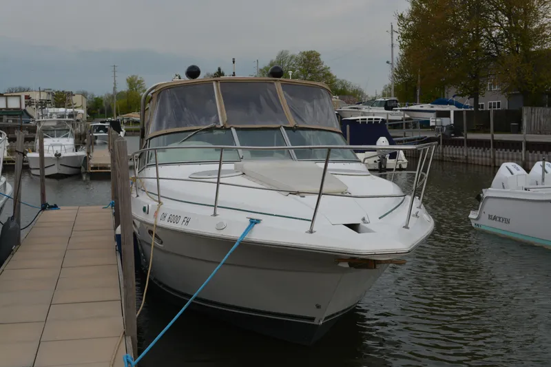 Slide: The Image of 1997 Cruisers Yachts 3120 Aria docked in a marina, front view. - 3