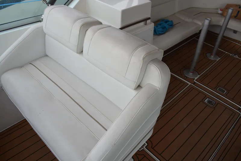 Slide: The Image of 1997 Cruisers Yachts 3120 Aria interior with white seating and wooden flooring. - 13
