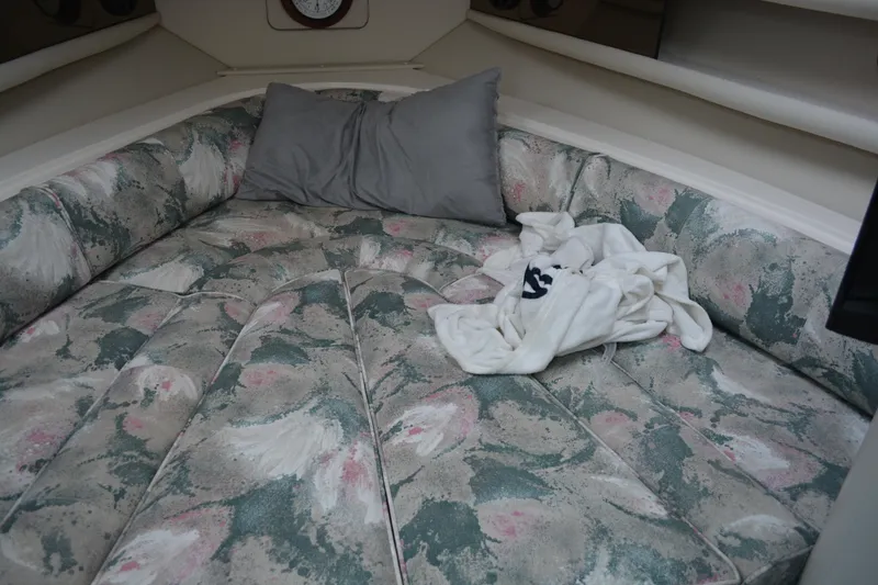 Slide: The Image of 1997 Cruisers Yachts 3120 Aria cabin interior with floral-patterned bedding and pillows. - 25