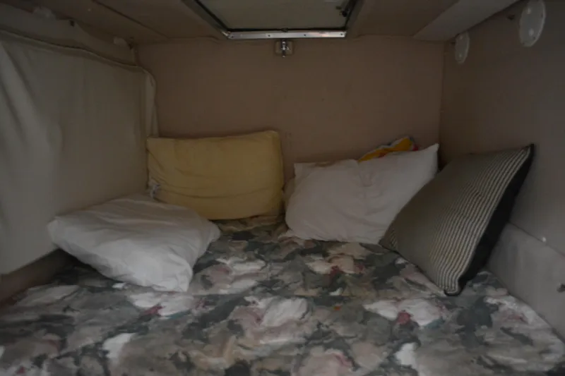 Slide: The Image of Cozy cabin interior of 1997 Cruisers Yachts 3120 Aria with pillows and patterned bedding. - 28