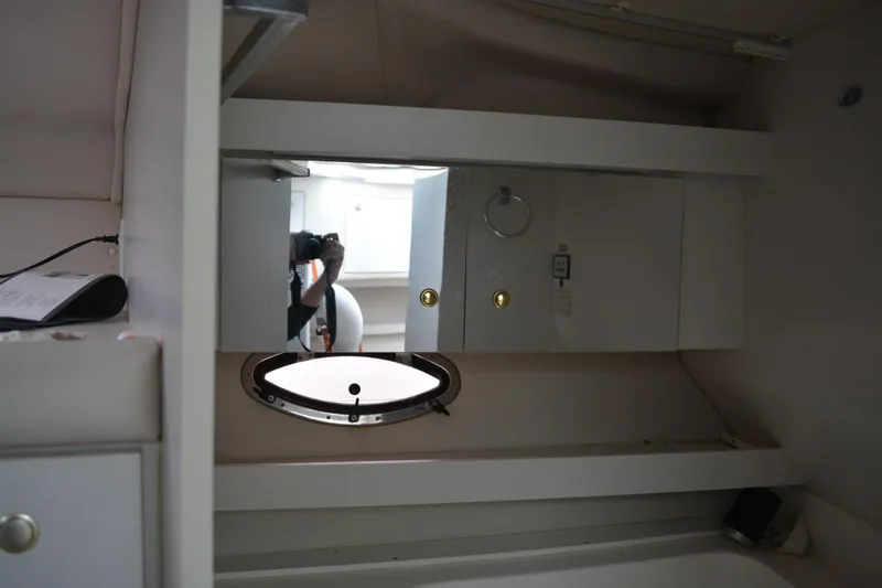 Slide: The Image of Interior of 1997 Cruisers Yachts 3120 Aria with porthole and cabinetry. - 31