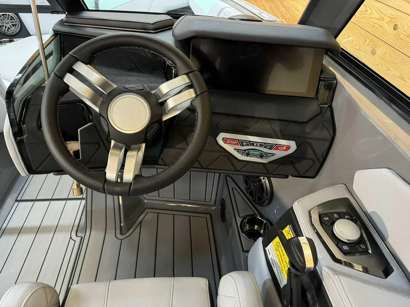 Slide: The Image of 2025 Nautique GS22 boat cockpit with modern steering wheel and control panel. - 7
