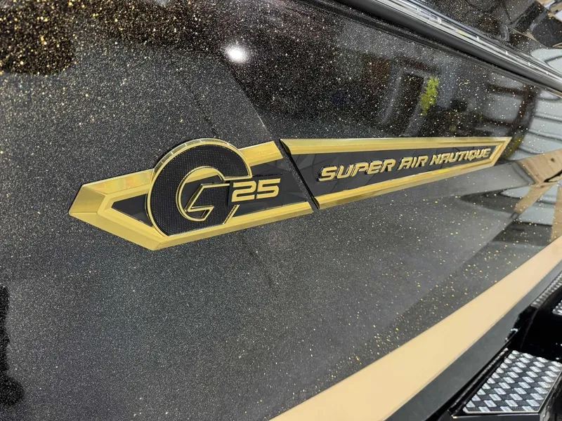 Slide: The Image of 2025 Nautique G25 Super Air logo on a sleek, glittering boat surface. - 4