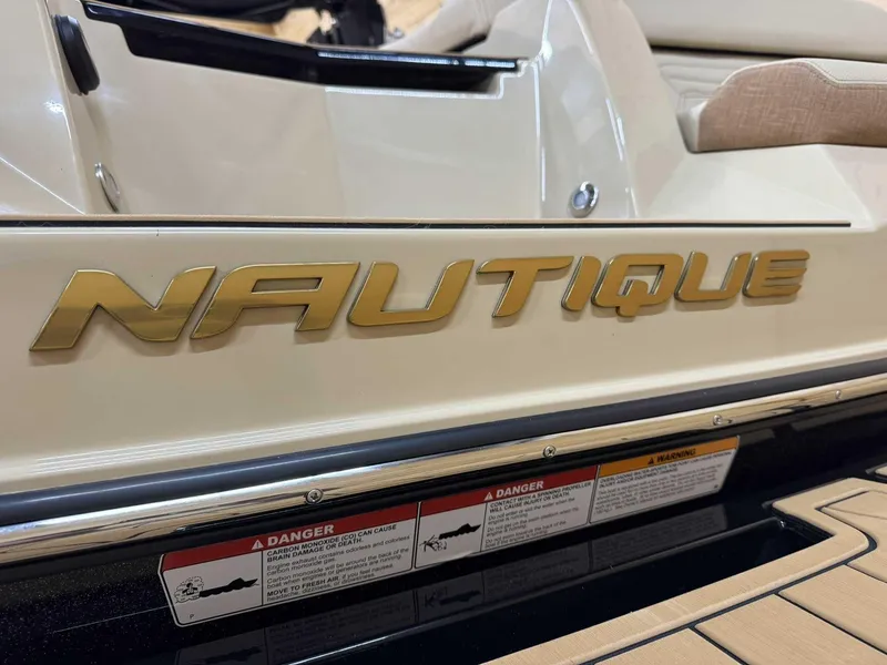 Slide: The Image of 2025 Nautique G25 boat with gold logo and safety warnings on deck. - 5