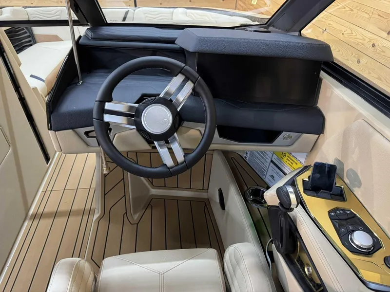 Slide: The Image of 2025 Nautique G25 boat interior with modern steering wheel and dashboard controls. - 7