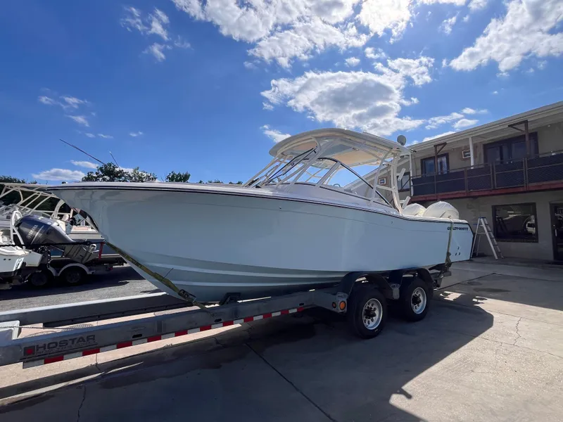 Slide: The Image of 2025 Grady-White Freedom 275 boat on trailer under a sunny sky. - 1