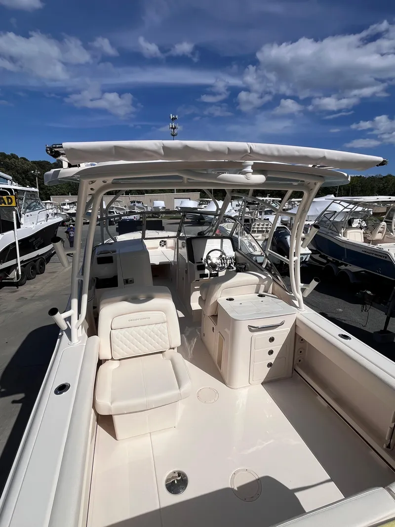 Slide: The Image of 2025 Grady-White Freedom 275 boat with spacious seating and sleek design under a clear sky. - 5