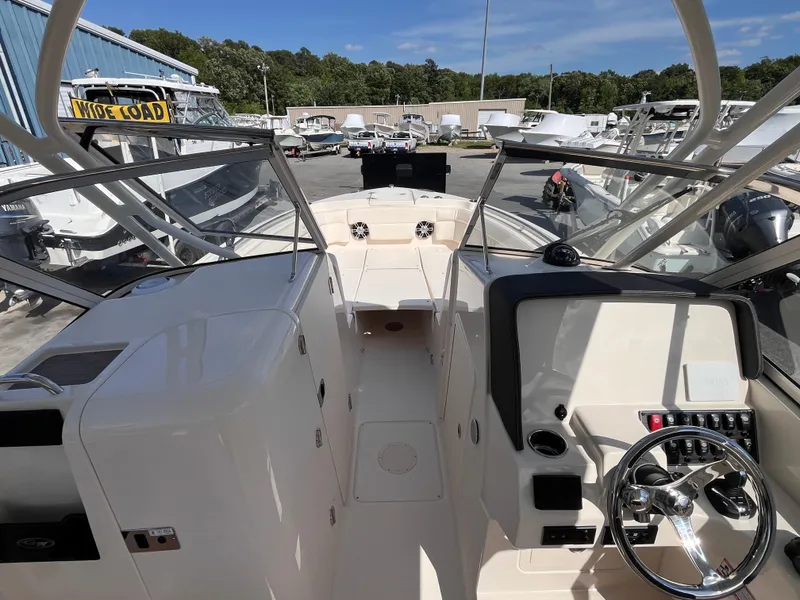 Slide: The Image of 2025 Grady-White Freedom 275 boat interior with steering wheel and dashboard. - 6