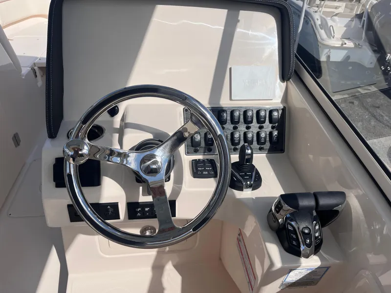 Slide: The Image of 2025 Grady-White Freedom 275 helm with steering wheel and control panel. - 8