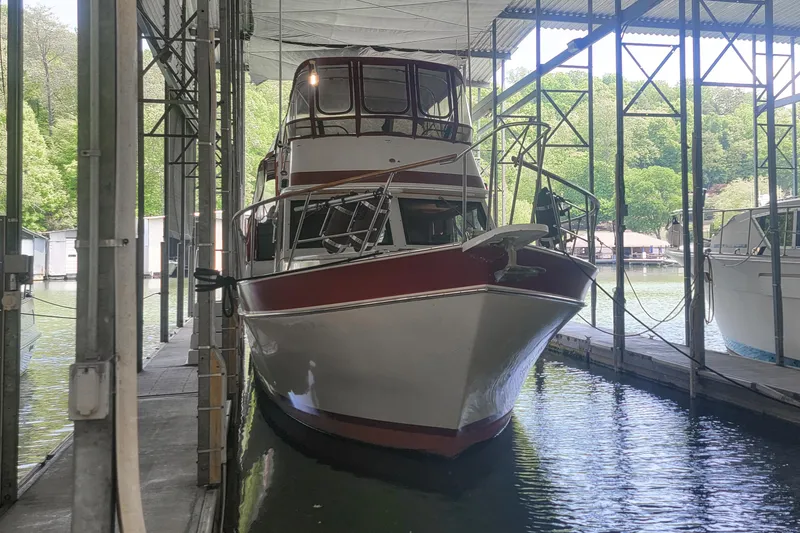 Slide: The Image of 1984 Wellcraft 44 Californian CMY docked in a covered marina. - 10