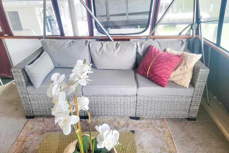 Slide: The Image of Luxurious seating area on 1984 Wellcraft 44 Californian CMY with elegant cushions and floral decor. - 17