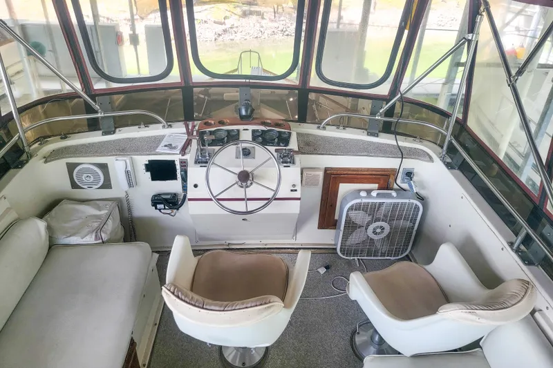 Slide: The Image of 1984 Wellcraft 44 Californian CMY helm with steering wheel, seating, and fan. - 20