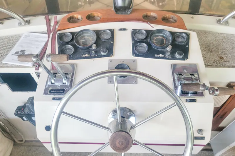 Slide: The Image of 1984 Wellcraft 44 Californian CMY helm with steering wheel and control panels. - 24