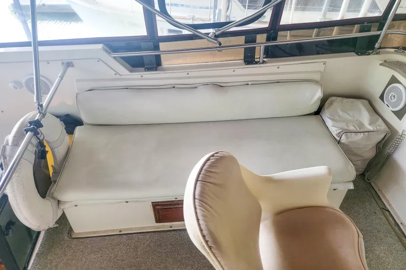 Slide: The Image of 1984 Wellcraft 44 Californian CMY interior with cushioned seating and helm chair. - 25