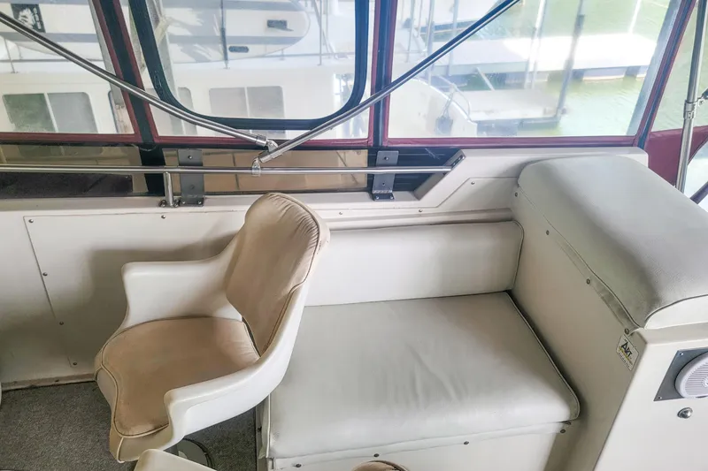Slide: The Image of Interior of 1984 Wellcraft 44 Californian CMY with white seating and large windows. - 26
