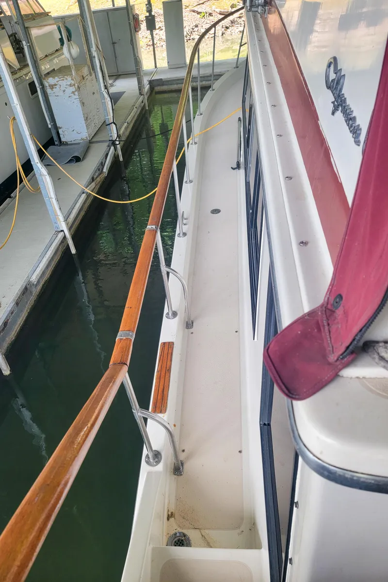 Slide: The Image of 1984 Wellcraft 44 Californian CMY docked, showing side deck and railing. - 29