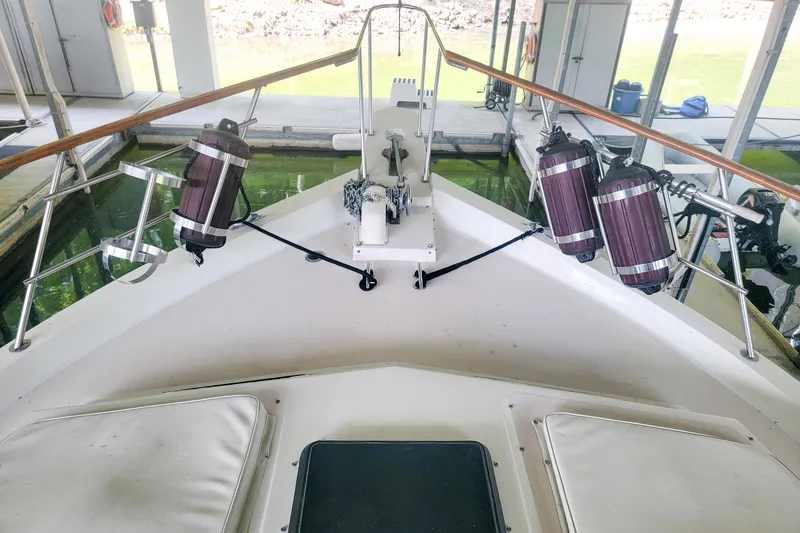 Slide: The Image of 1984 Wellcraft 44 Californian CMY yacht bow with fenders and anchor in marina. - 33