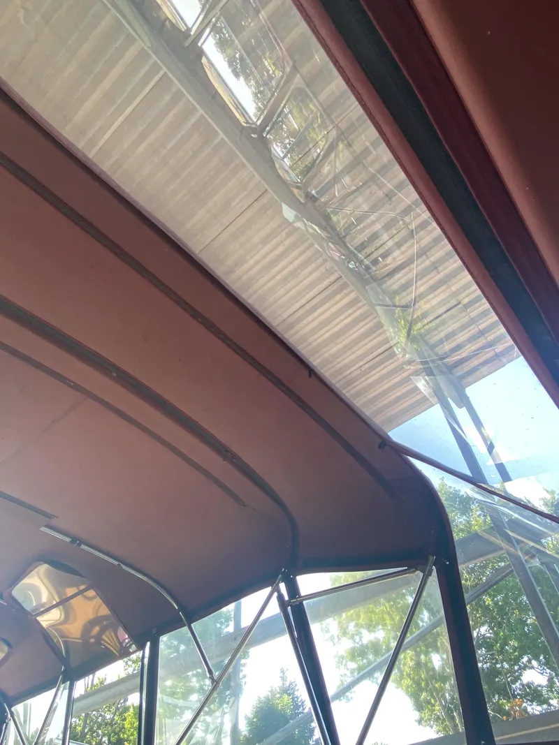 Slide: The Image of 1984 Wellcraft 44 Californian CMY boat interior with canopy and clear sky view. - 37