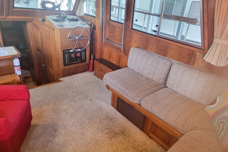 Slide: The Image of Interior of 1984 Wellcraft 44 Californian CMY with cozy seating and wooden accents. - 38