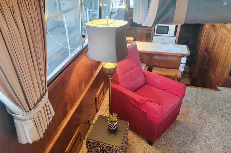 Slide: The Image of Interior of 1984 Wellcraft 44 Californian CMY with red chair, lamp, and wooden accents. - 39