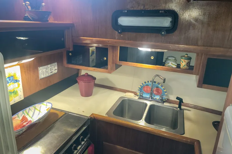 Slide: The Image of 1984 Wellcraft 44 Californian CMY kitchen with double sink, stove, and wooden cabinetry. - 43