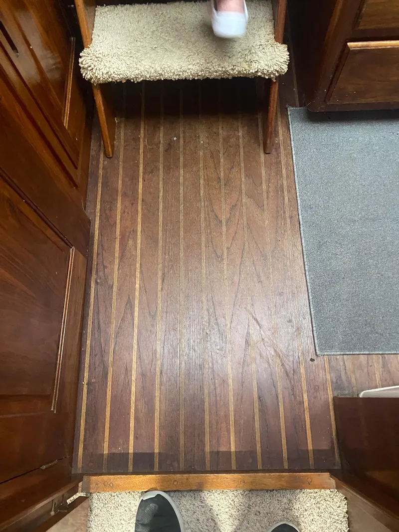 Slide: The Image of Interior view of 1984 Wellcraft 44 Californian CMY with wooden flooring and carpeted steps. - 44