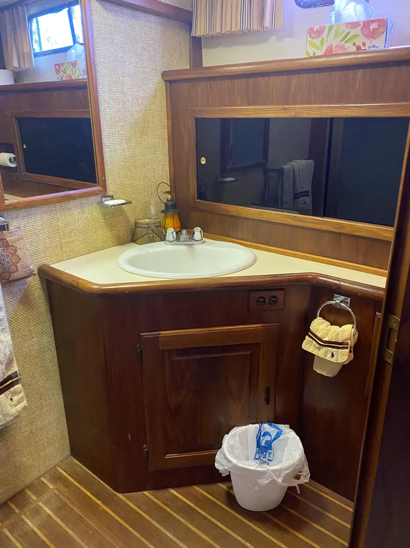 Slide: The Image of 1984 Wellcraft 44 Californian CMY bathroom with wooden cabinetry and sink. - 46