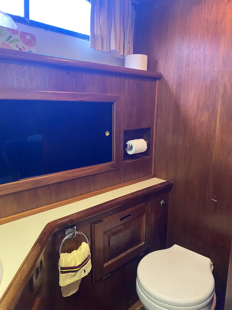 Slide: The Image of 1984 Wellcraft 44 Californian CMY bathroom with wooden cabinetry and modern fixtures. - 47