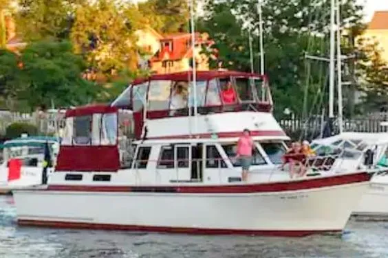 Slide: The Image of 1984 Wellcraft 44 Californian CMY yacht on water, surrounded by trees and buildings. - 5