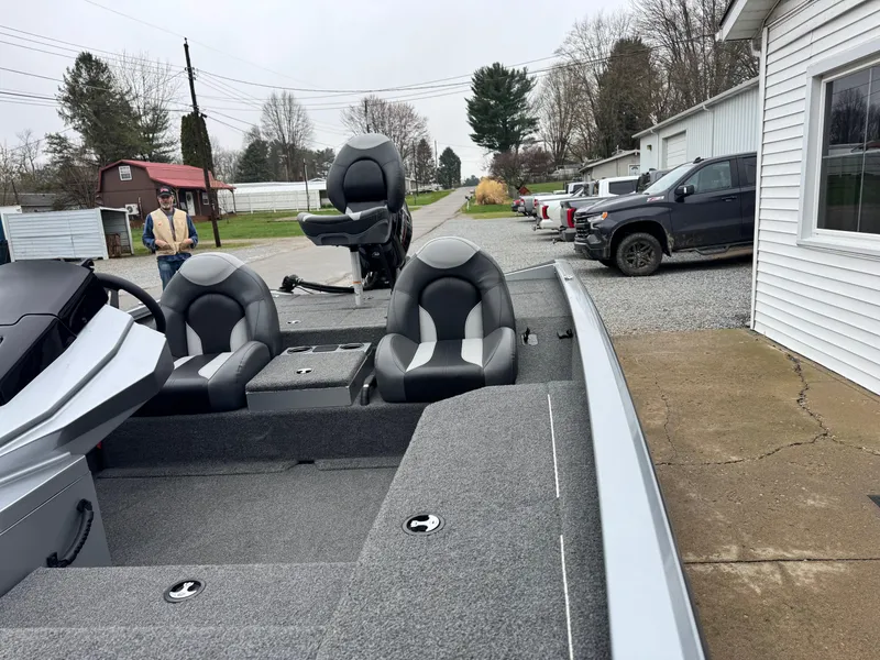 Slide: The Image of 2022 Vexus AVX181 boat with gray interior, parked outdoors near vehicles and buildings. - 9