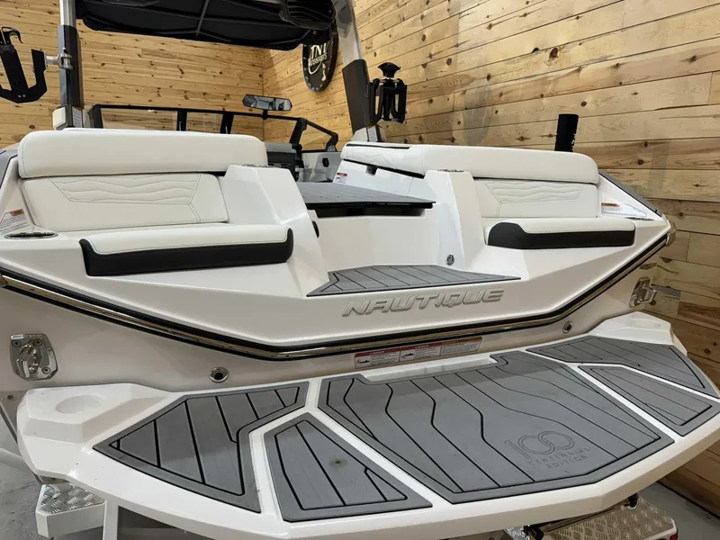 Slide: The Image of 2025 Nautique G25 boat with sleek design and comfortable seating in a wooden interior setting. - 3