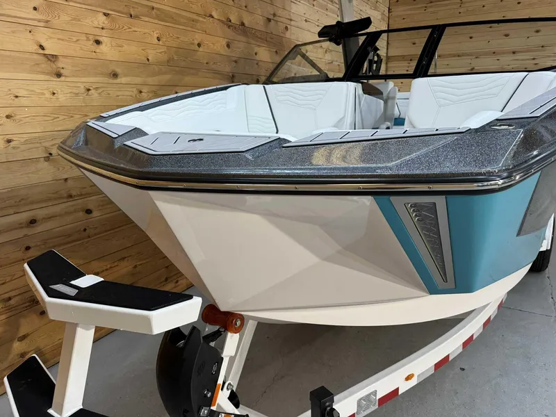 Slide: The Image of 2025 Nautique G25 boat in showroom, featuring sleek design and modern interior. - 6