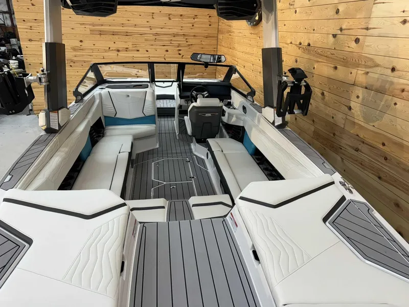 Slide: The Image of 2025 Nautique G25 boat interior with sleek white seating and modern design. - 7