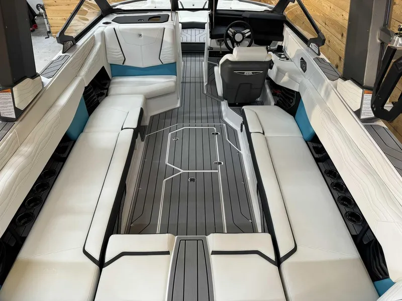 Slide: The Image of 2025 Nautique G25 boat interior with sleek white seating and modern design. - 8